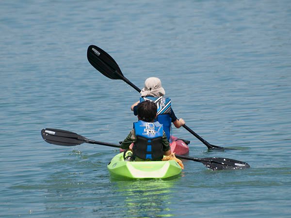 Photo of two young children in a kayak.