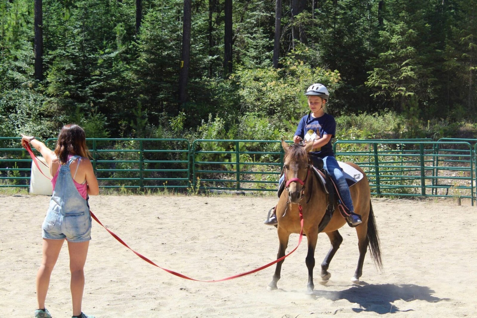 A girl learning how to ride a horse.