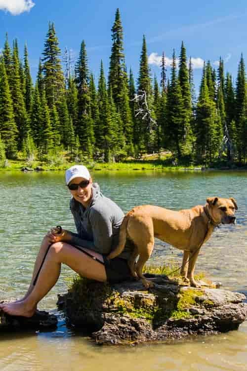 Hiker and her best friend taking a break at Ten Lakes Scenic Area. Photo: Aaron Theisen