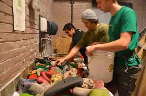 Reggae beats bump overhead, the sound of drills bounce off the walls, setters swing from ropes, holds fall from the sky, bolts and colored tape litter the floor and buckets full of grimy holds wait patiently for their vinegar bath. Photo: Brad Myers