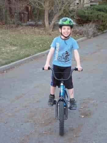 The author's son all smiles on the right bike.