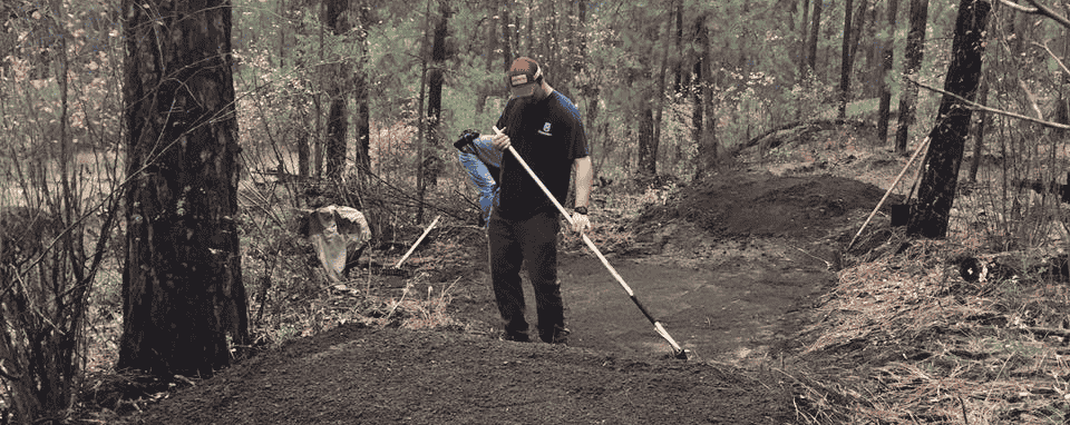 Photo of Evergreen East member completing trail maintenance.