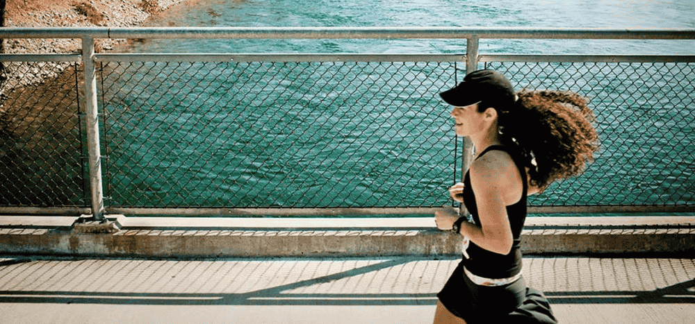 Photo of runner on bridge over the Spokane River.