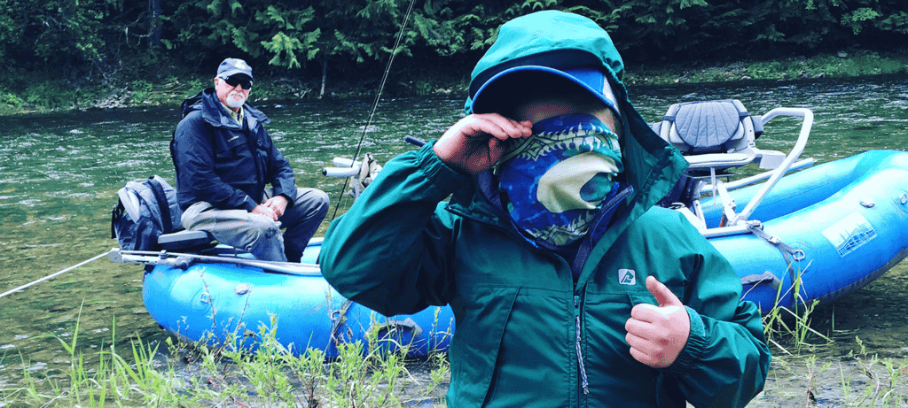 Photo of young boy and grandfather along the river edge.