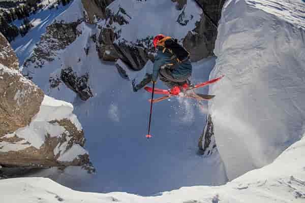 Photo of skier mid-air taken from below.