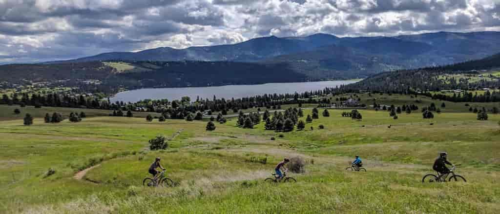 Photo of mountain bikers at the Saltese Uplands from above.