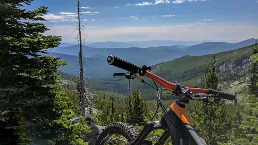 Mountain bike on a trail in the Colville National Forest with a view of the Kettle Crest Range.