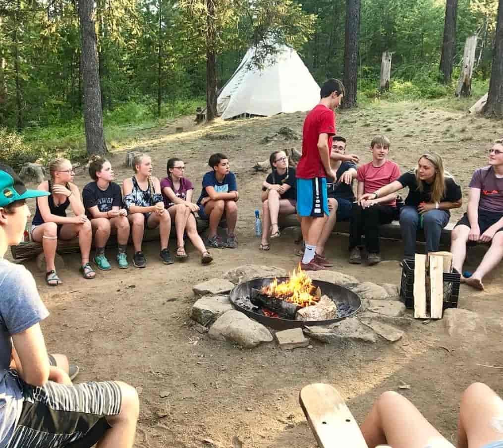 A group of kids around a campfire.