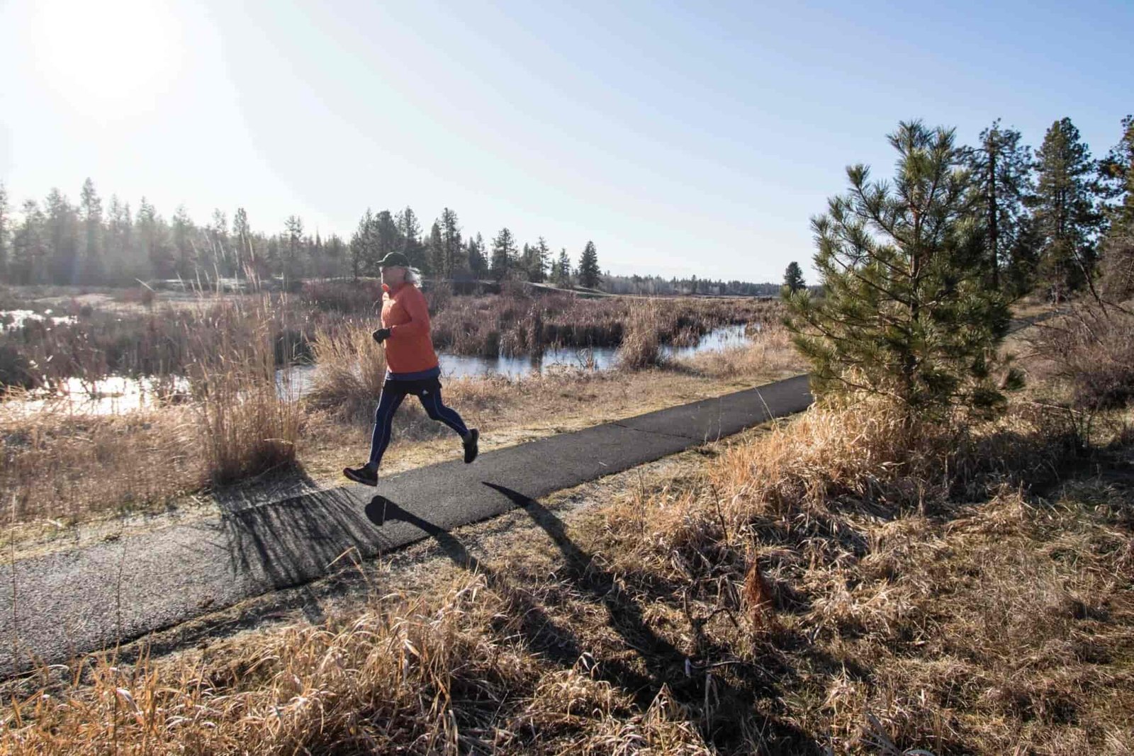 A person running down a paved trail.