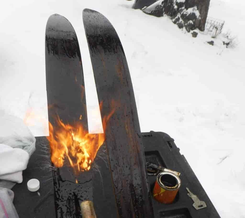 Vintage wooden skis getting a pine tar treatment.