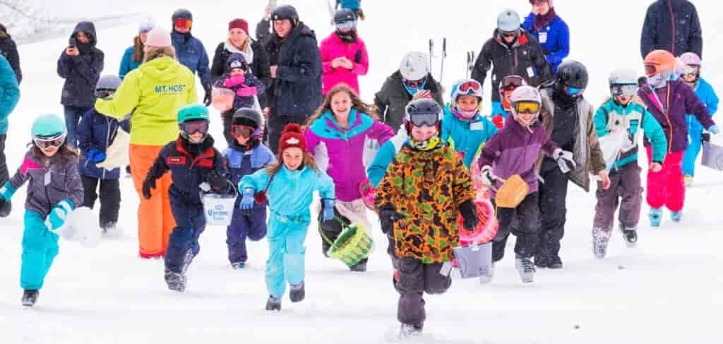 Ski kids racing through the snow.