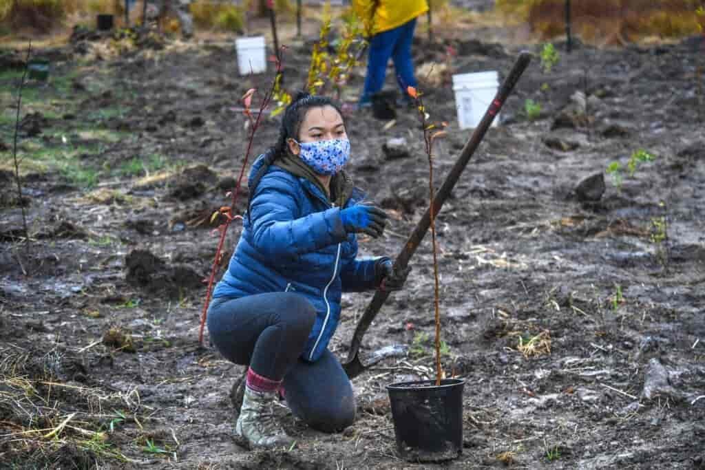 Woman at the tree planting event holding a shovel.