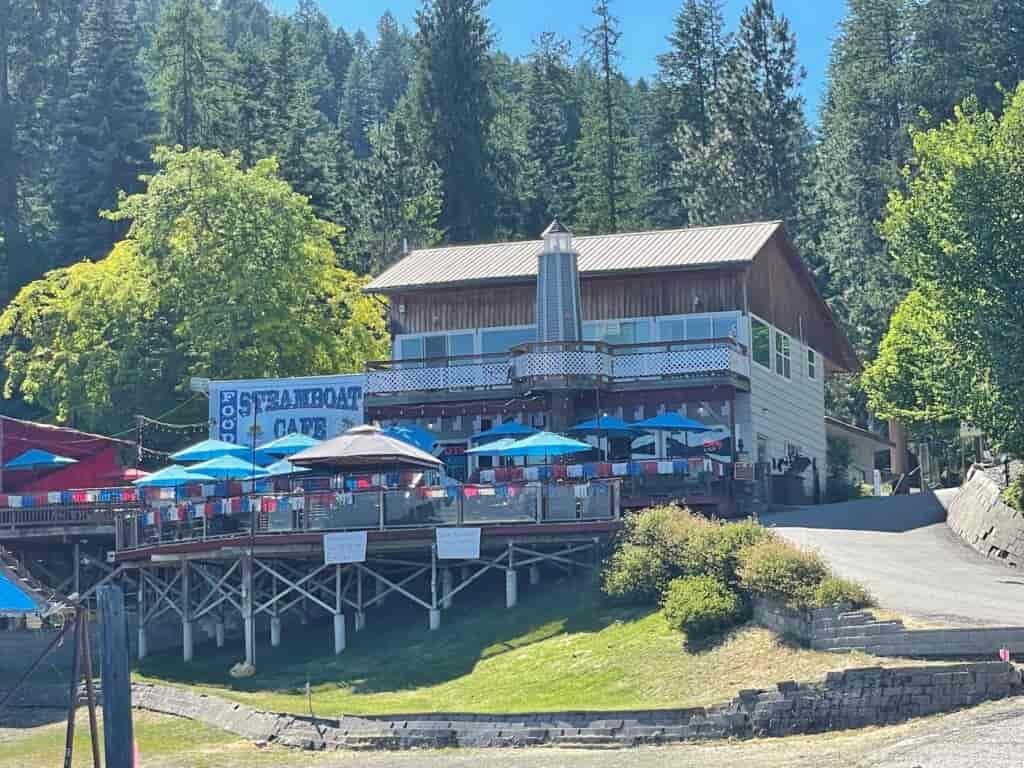Conkling Marina and Resort featuring large elevated dining deck with table umbrellas and lodge with wraparound deck-balcony.